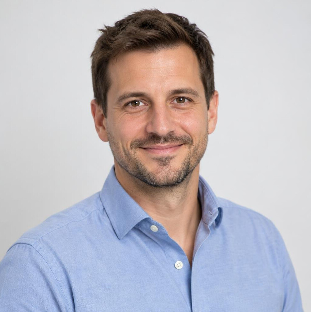 Portrait of a smiling man in his thirties in a smart casual shirt